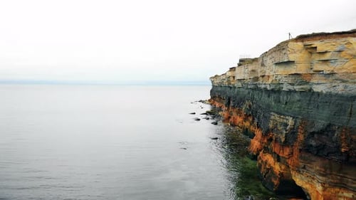 Drone Is Moving Along Incredible Eroded Rocky Layers Coastline Above Amazing Quiet Sea Waters