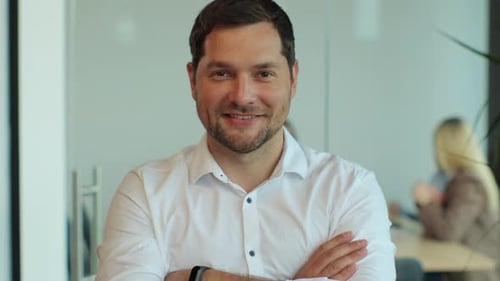 Portrait of Businessman with Arms Crossed in Office