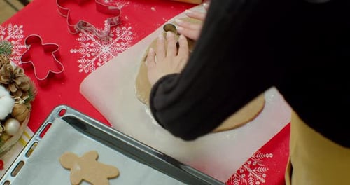 Woman Making Gingerbread Men Cookies for Christmas