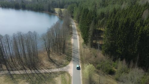 Car Driving on Country Road by Lake, Aerial View