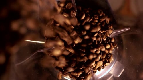 Coffee Beans Filling up the Grinder