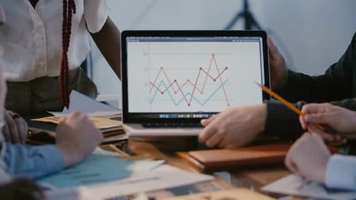 Close-up Shot, Male Office Worker Hands Showing Marketing Diagram on Laptop Screen at Multiethnic
