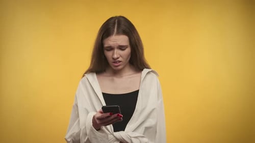 Distraught Woman Using a Mobile Phone
