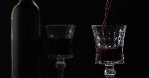 Red Wine Being Poured Into a Glass