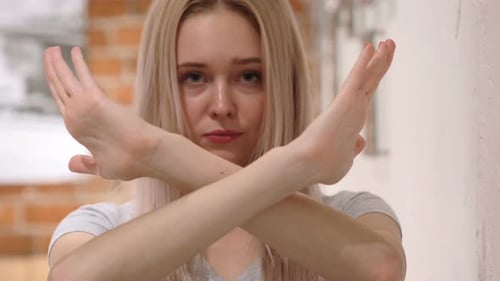 Young Woman Expressing Denial with Crossed Arms