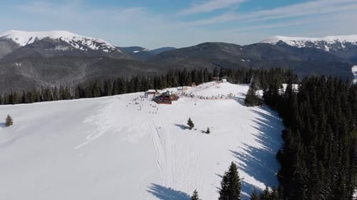 Aerial Ski Slopes with Skiers and Ski Lifts on Ski Resort. Snowy Mountain Forest