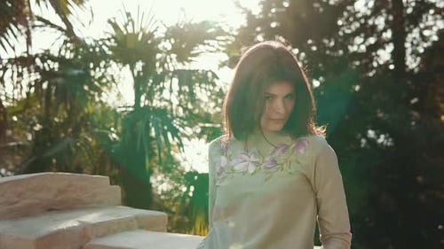 Young and Pretty Woman Is in a Tropical Forest with Palm Trees in the Daytime