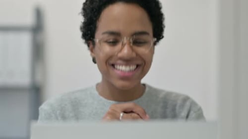 Woman Waving and Talking to Laptop Screen