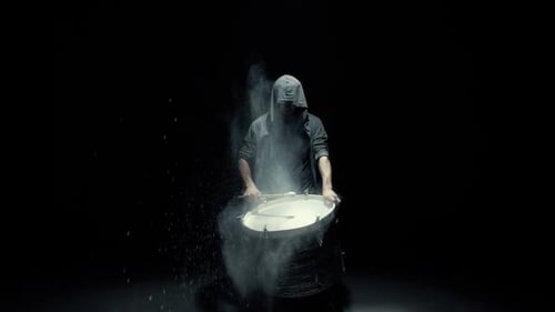 Hooded Drummer Playing Drum with White Powder