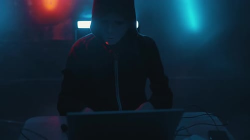 Hacker is Working on Laptop at Night