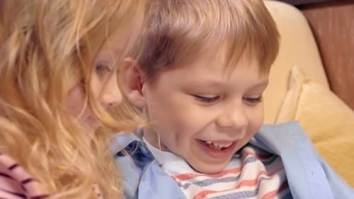 Happy Boy and Girl Laughing Together Indoors