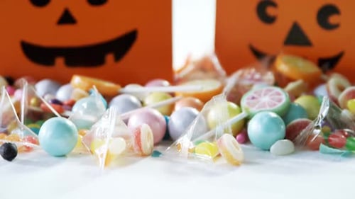 Candy Pile With Orange Halloween Treat Bags