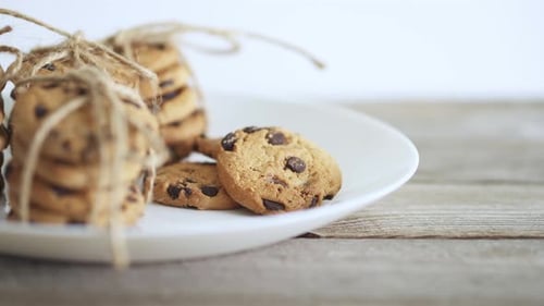 Chocolate Chip Cookies on Plate Being Taken