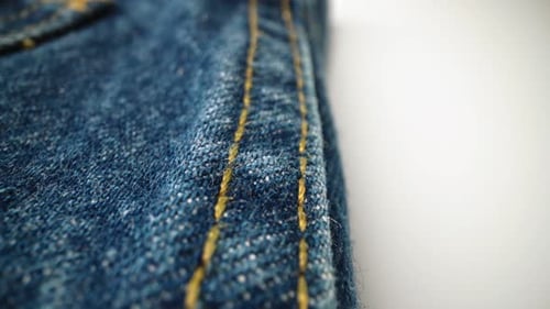 Denim Fabric Macro Close-Up with Yellow Stitching