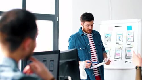Male Ui Designer Showing User Interface at Office