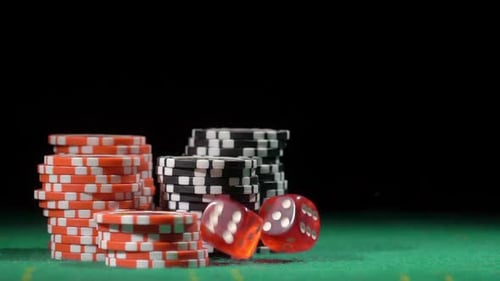 Casino Chips and Dice on Green Table