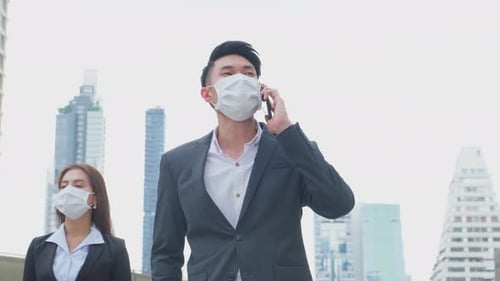 Group of young office businesspeople use phone call walk, outdoor in city with new normal lifestyle