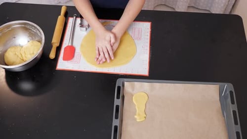 Child Preparing Christmas Cookies at Kitchen Table