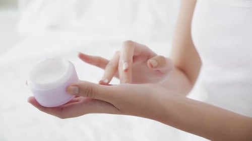 Young Adult Applying White Beauty Cream