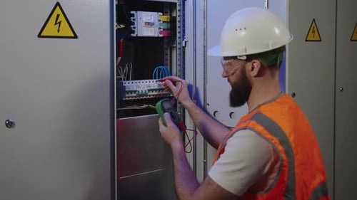 Electrician Testing Electrical Box With Multimeter