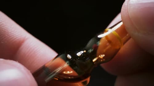 Fingers Hold Glass Medical Ampule Close-Up