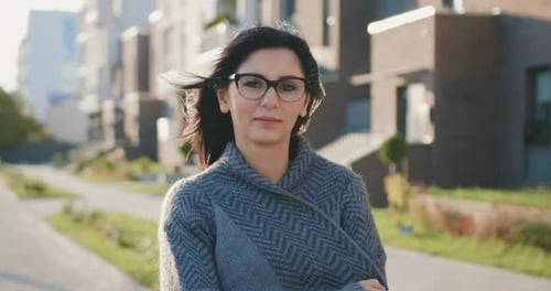 Woman Standing on Sidewalk in Residential Area