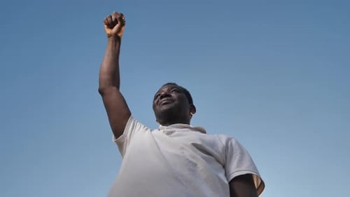 Man Raising Fist in the Air in Victory