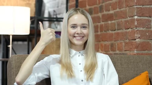 Blonde Woman Giving Thumbs Up on Couch