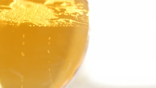 Glass of beer close-up slow tilting 4K 2160p UltraHD footage - Golden beer color and bubbles in the