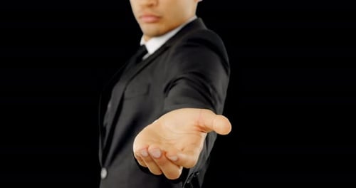 Man in Suit Offers Handshake on Black Background