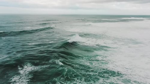 Beautiful Ocean with Foamy Waves Under Cloudy Sky Upper View