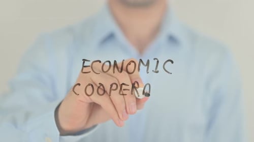 Man Writes Economic Cooperation on Clear Surface