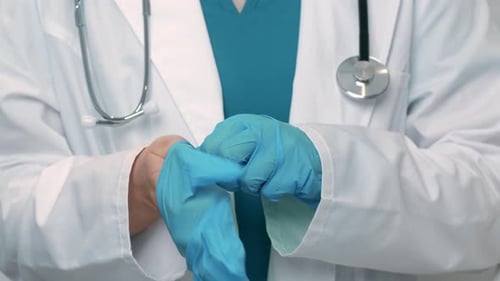 Close Up of Doctor Putting on Disposable Protective Gloves Before Appointment Slow Motion
