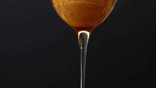 Golden Honey Drips in Viscous Close Up Shot