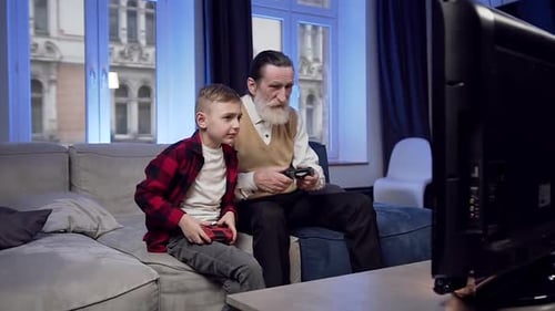 Grandfather and Grandson Play Video Games Together