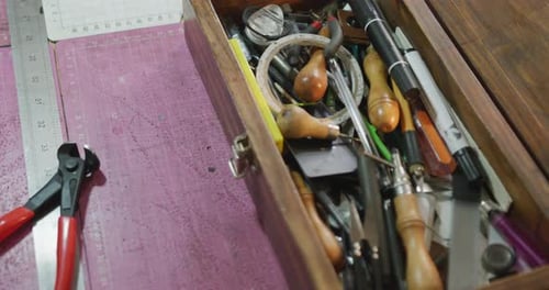 Close up of box full of tools in leather workshop
