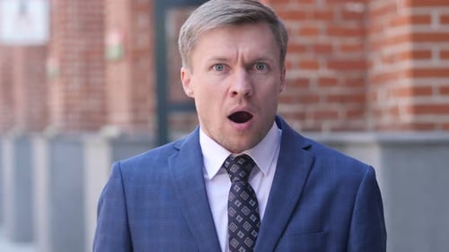 Portrait of Wondering Businessman in Shock Outside Office