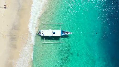Wide angle drone tourism shot of a sandy white paradise beach and blue water background in high resolution