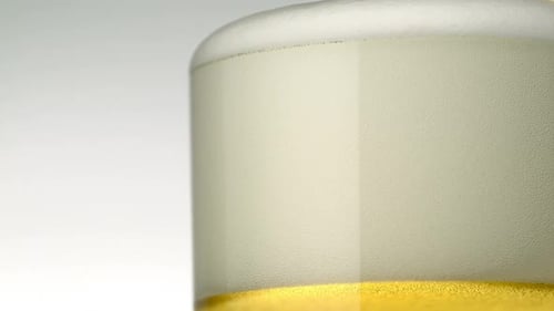 Close-Up of Beer with Bubbly Foam Head
