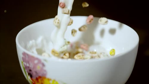 Cereal and Milk Being Poured Into Bowl