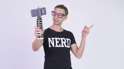 Studio Shot of Nerd Man Vlogging with Phone
