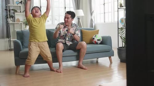 Dad and Son Cheering Sport Win on TV