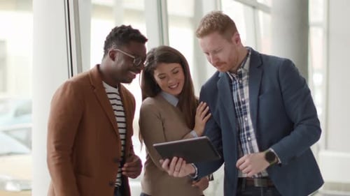 Three Colleagues Collaborating on a Tablet