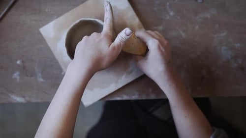 Artist Working with Clay to Shape Bowl