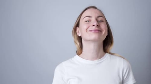 A Close-up Portrait of a Woman Removes a Medical Mask During the Quarantine of the COVID-19 Virus