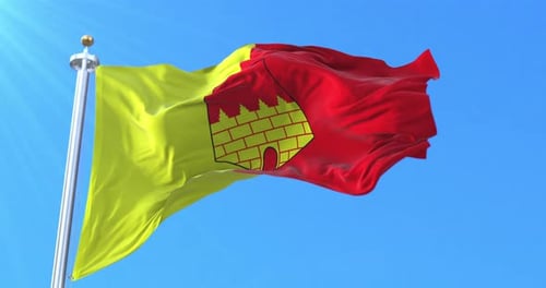 Realistic Waving Flag of Ciudad Real City Emblem Against Blue Sky