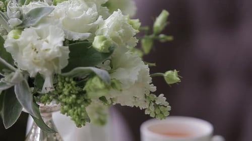 Elegant White Flowers and Tea on Table