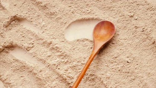 Drawing Heart in Brown Baking Powder with Spoon