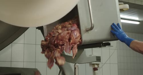 Raw Meat Poured into Bowl in Commercial Kitchen