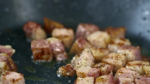 Salting Bacon Frying in Pan